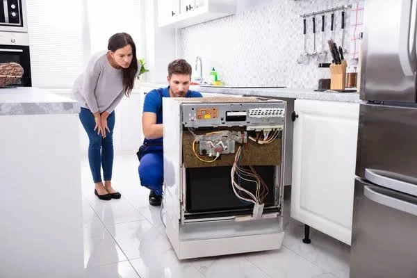 Homeowner and technician discussing an appliance repair