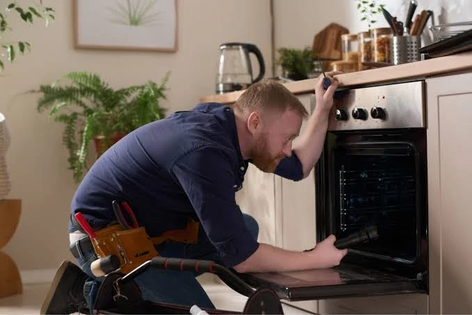 Technician examining an oven interior